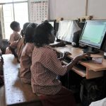 Children at a SCAD school learning how to use computers